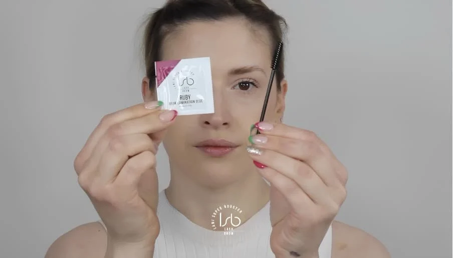 Apply Ruby glue on a spoolie and brush the eyebrows into shape
